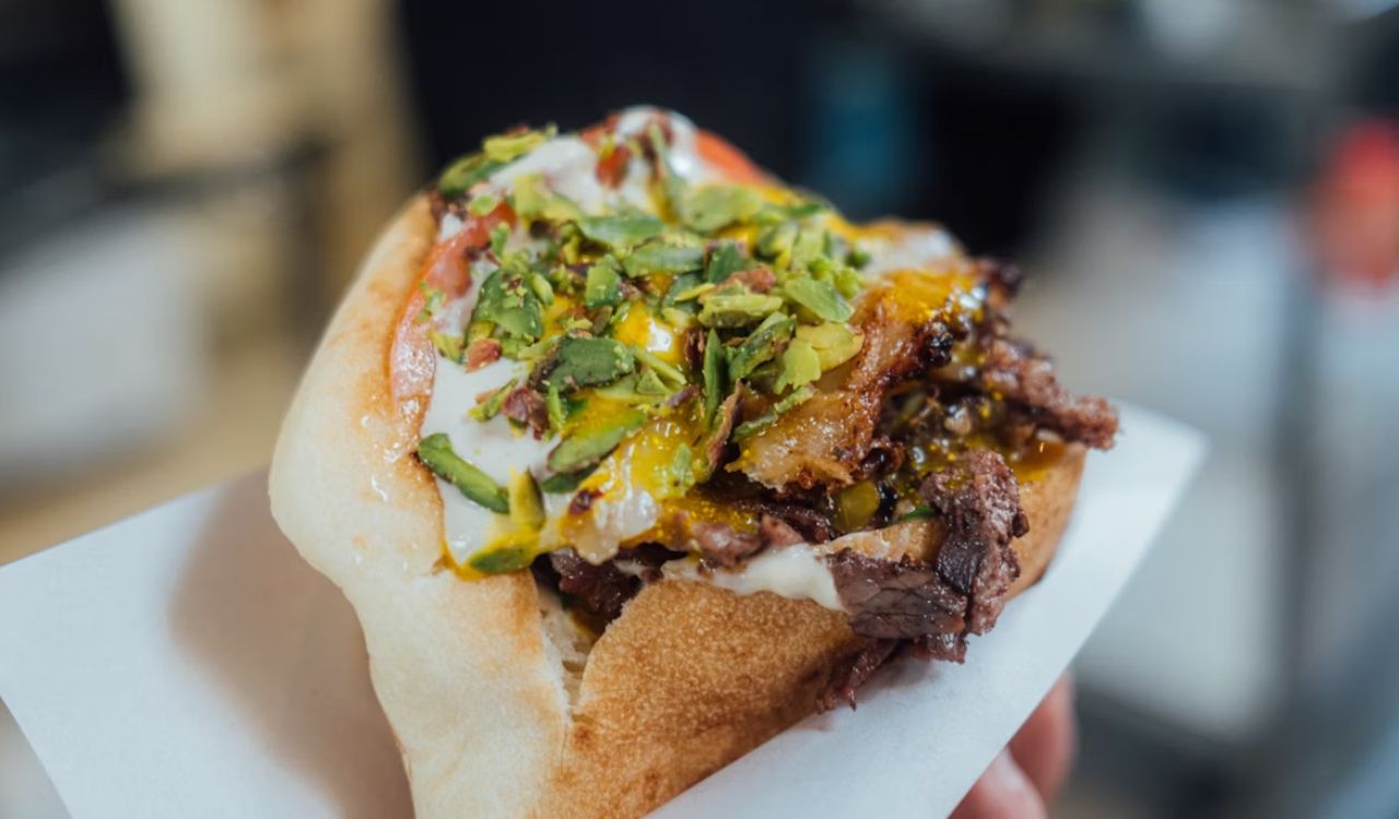 A person holding shawarma