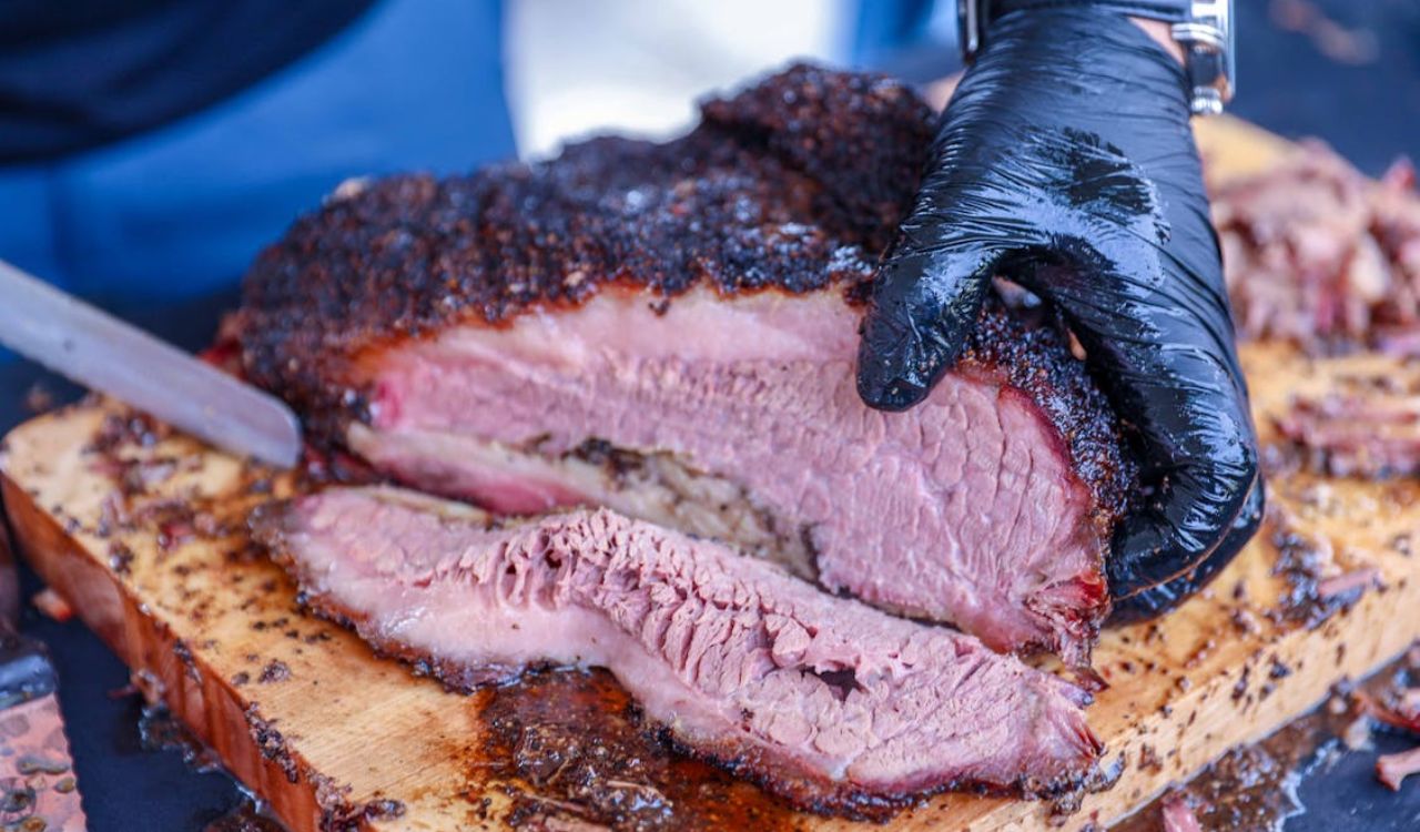 A person slicing barbecue beef brisket