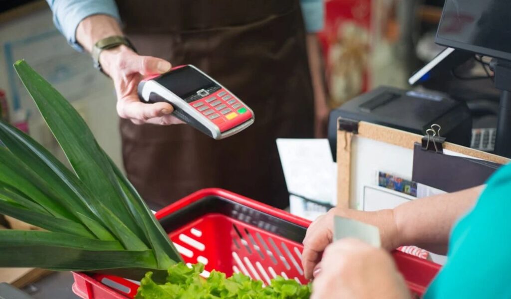 A shopper using card at the counter