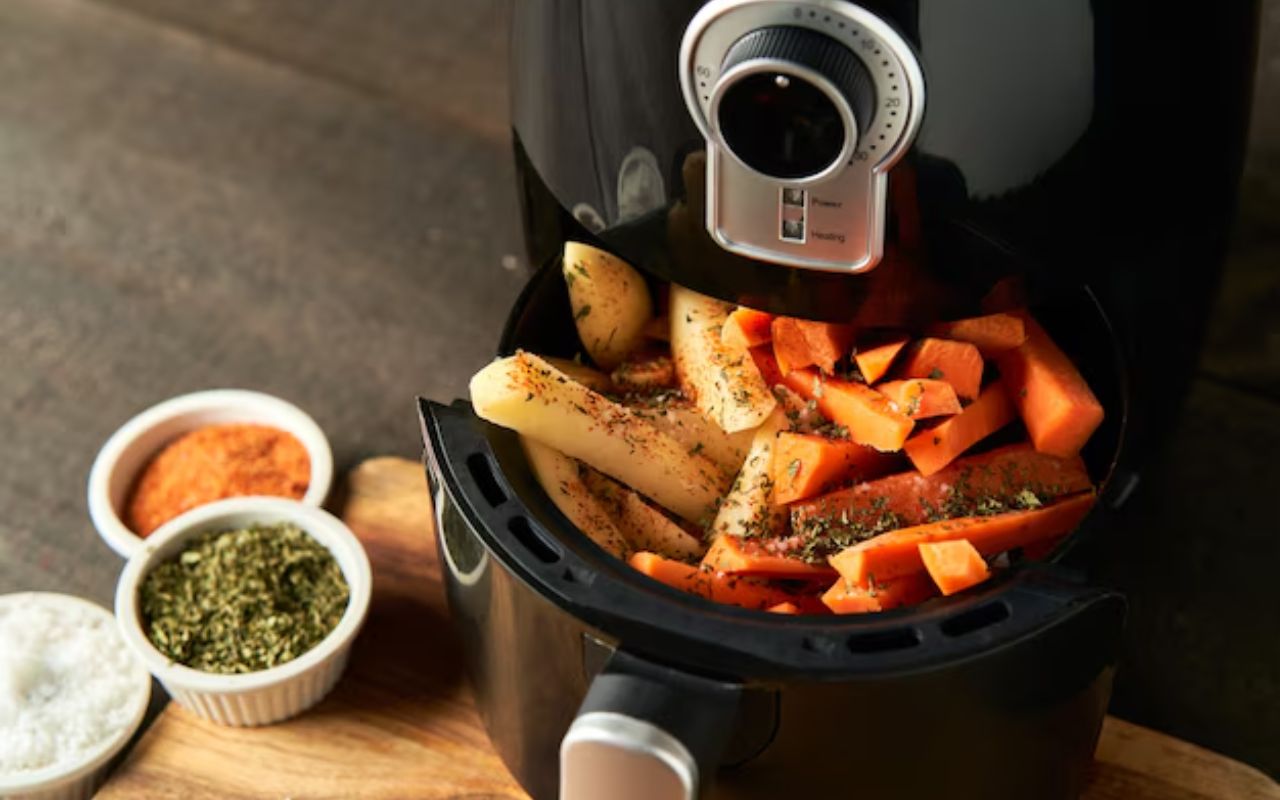 Air fryer with seasoned potato and carrot fries