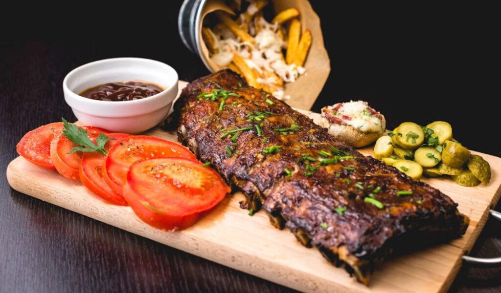 Barbecue ribs with sliced tomatoes and potatoes