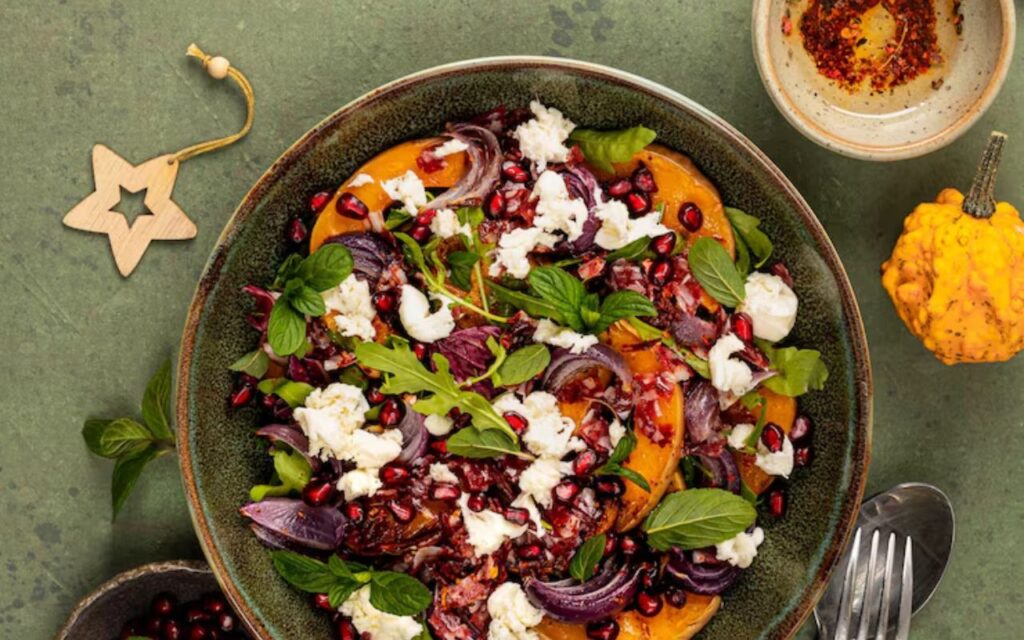 Bowl of beet and goat cheese salad with pomegranate and herbs