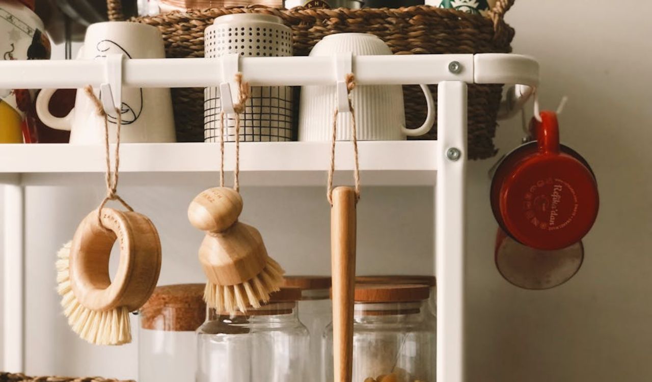 Brown Wooden Brush Hanging on White Plastic Rack
