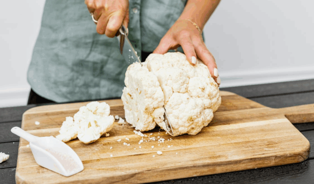 Person Slicing White Cauliflower