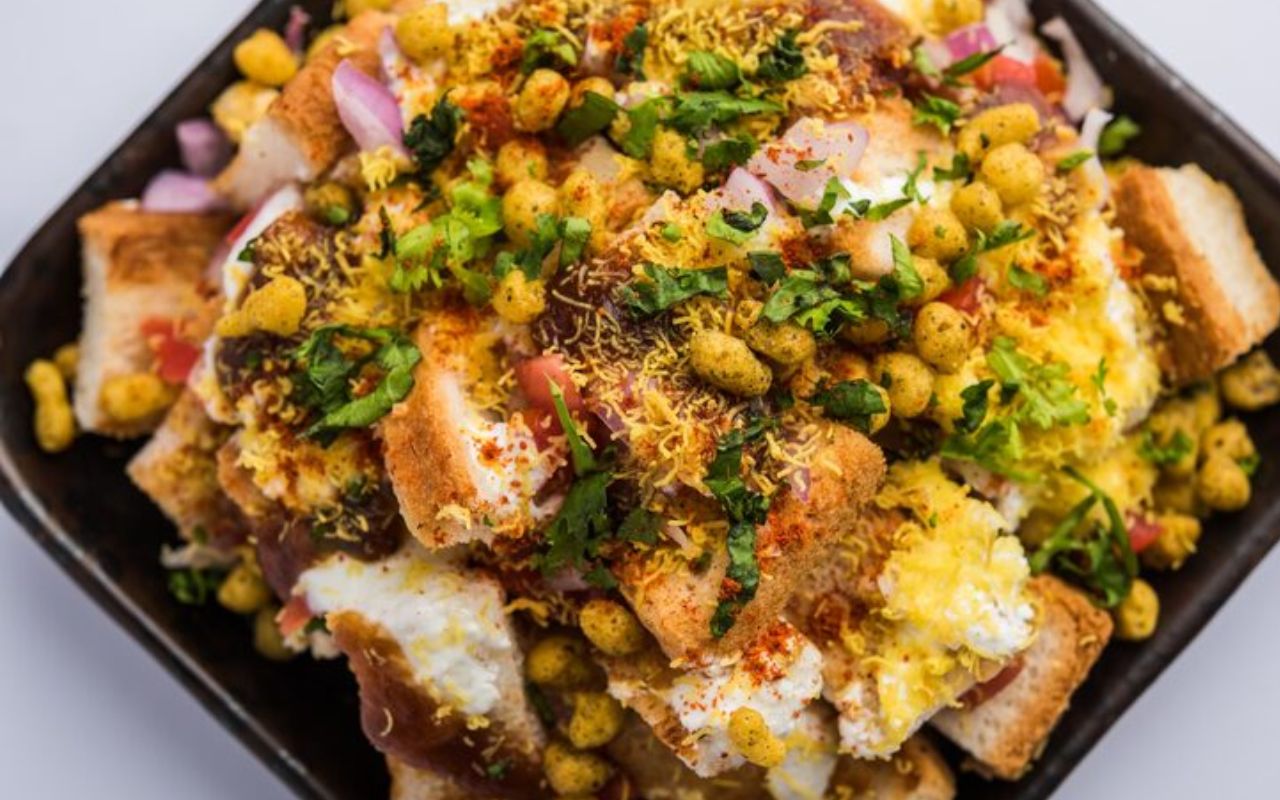 Indian chaat topped with sev, spices, and fresh herbs