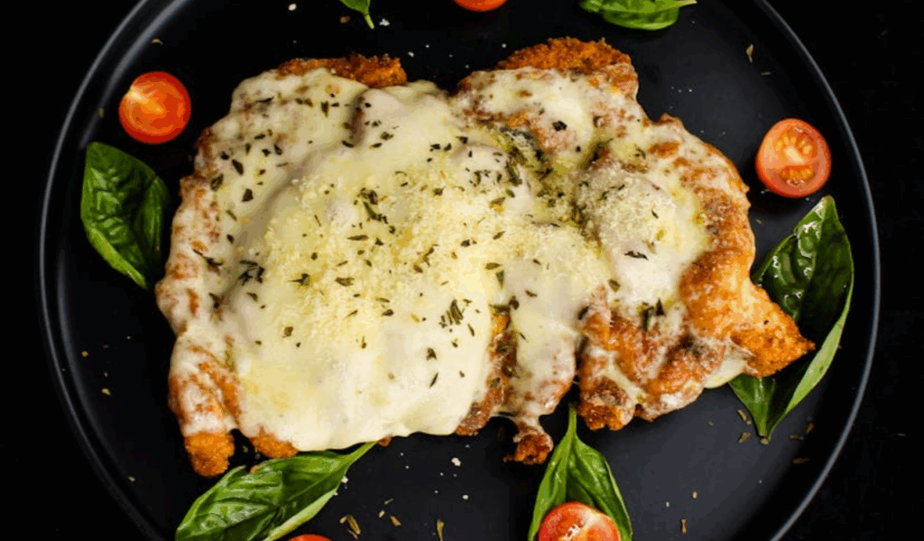 Cooked Chicken with Creamy Topping on a Ceramic Plate