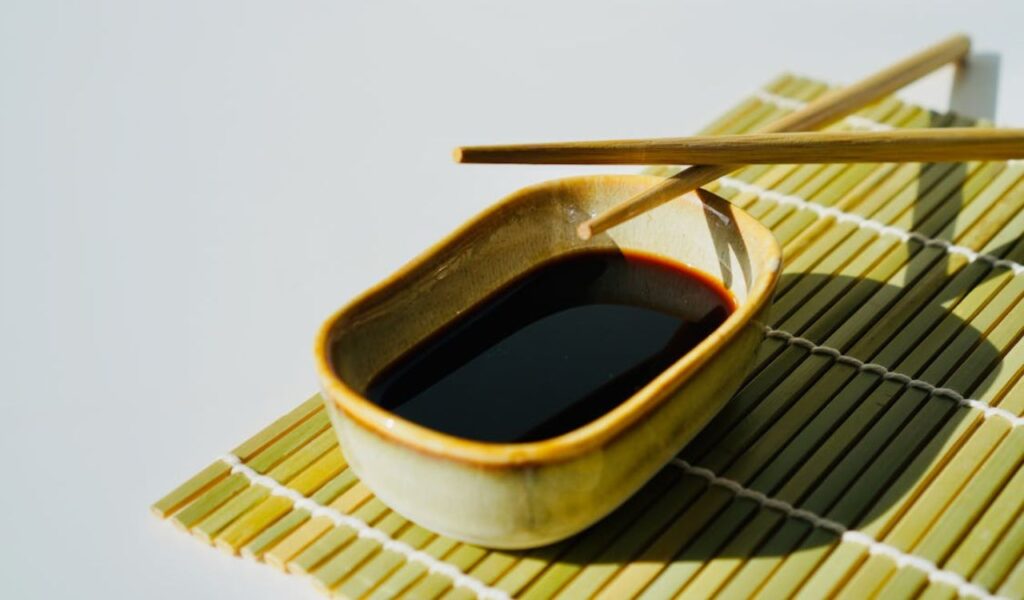 Chopsticks over bowl of soy sauce