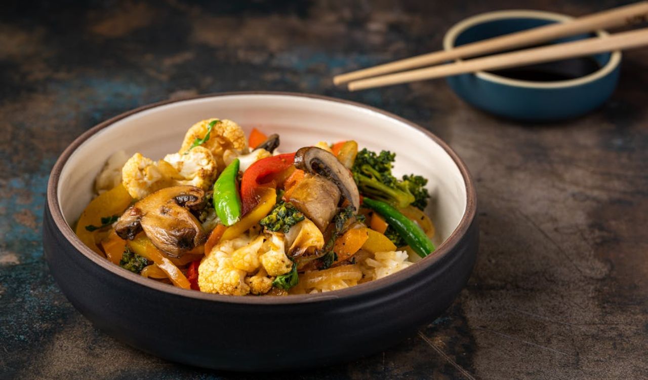 Cooked Food in a Bowl Beside Chopsticks