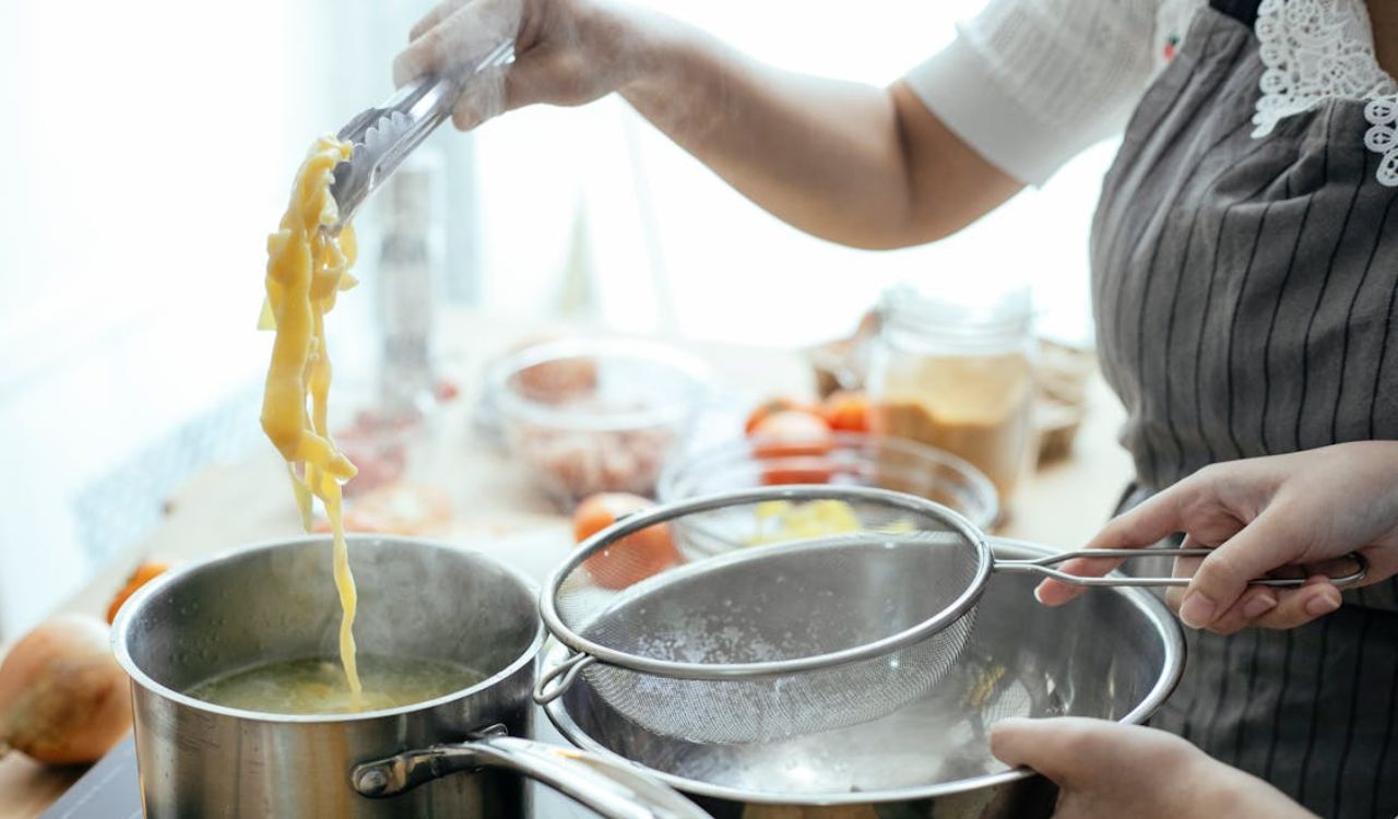 Cooks preparing pasta