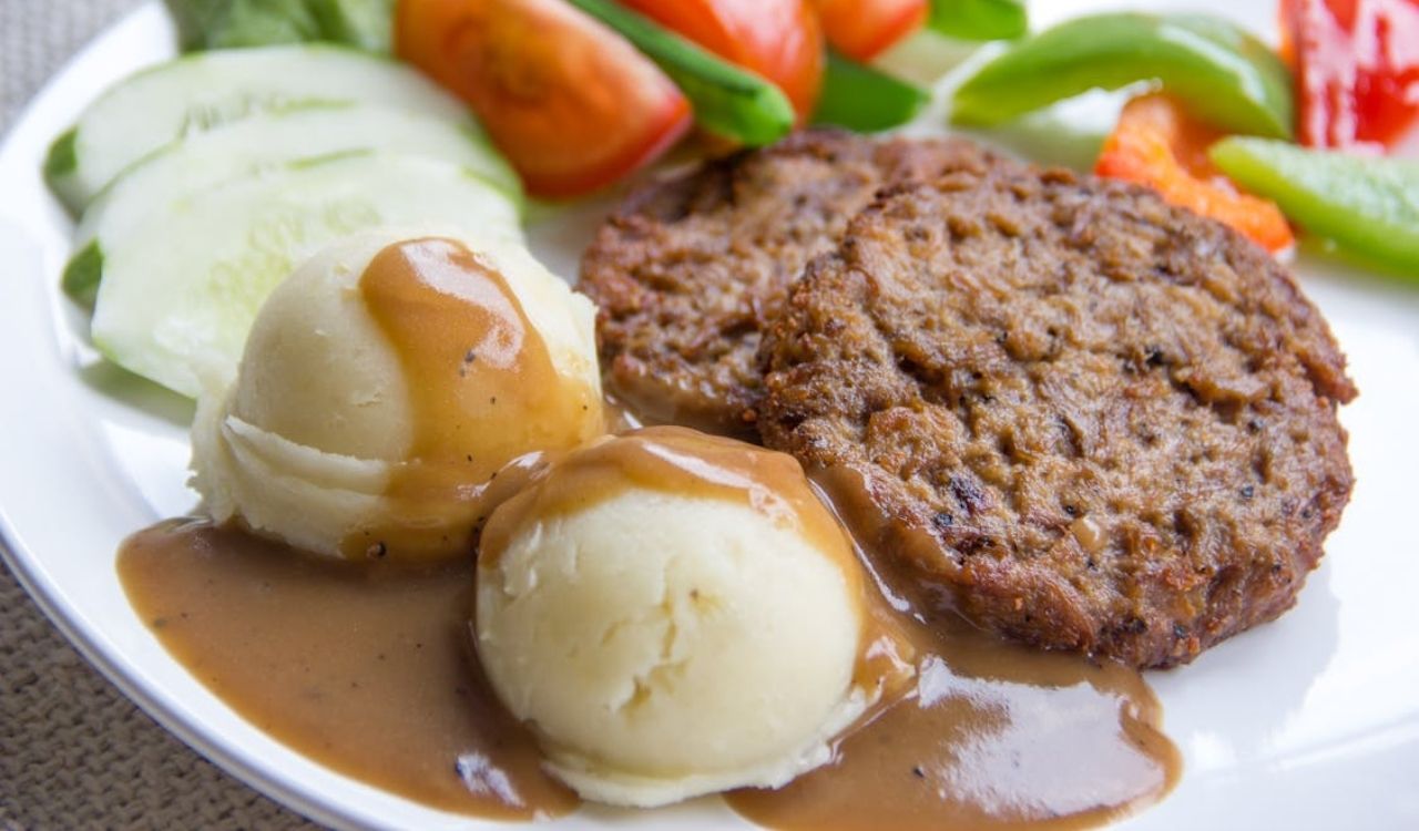 Close-up shot of mashed potatoes and gravy