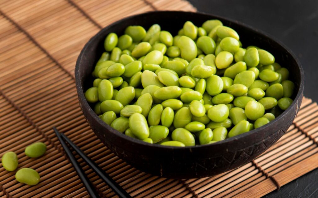 Bowl of shelled edamame beans with chopsticks