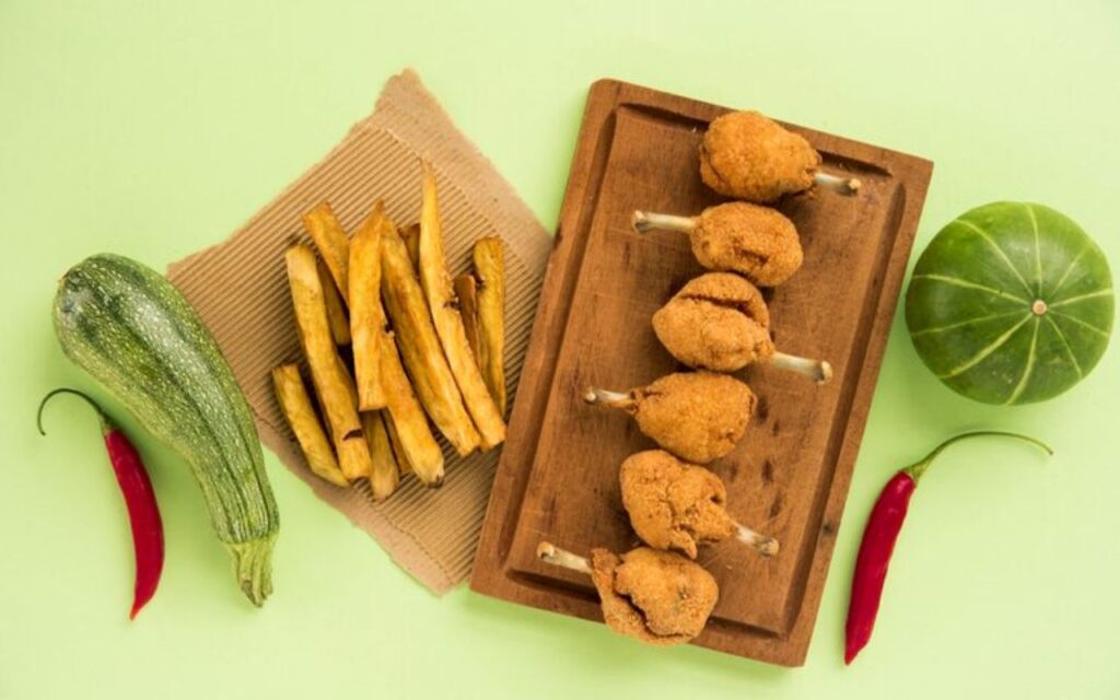 Fried snacks on sticks with fries