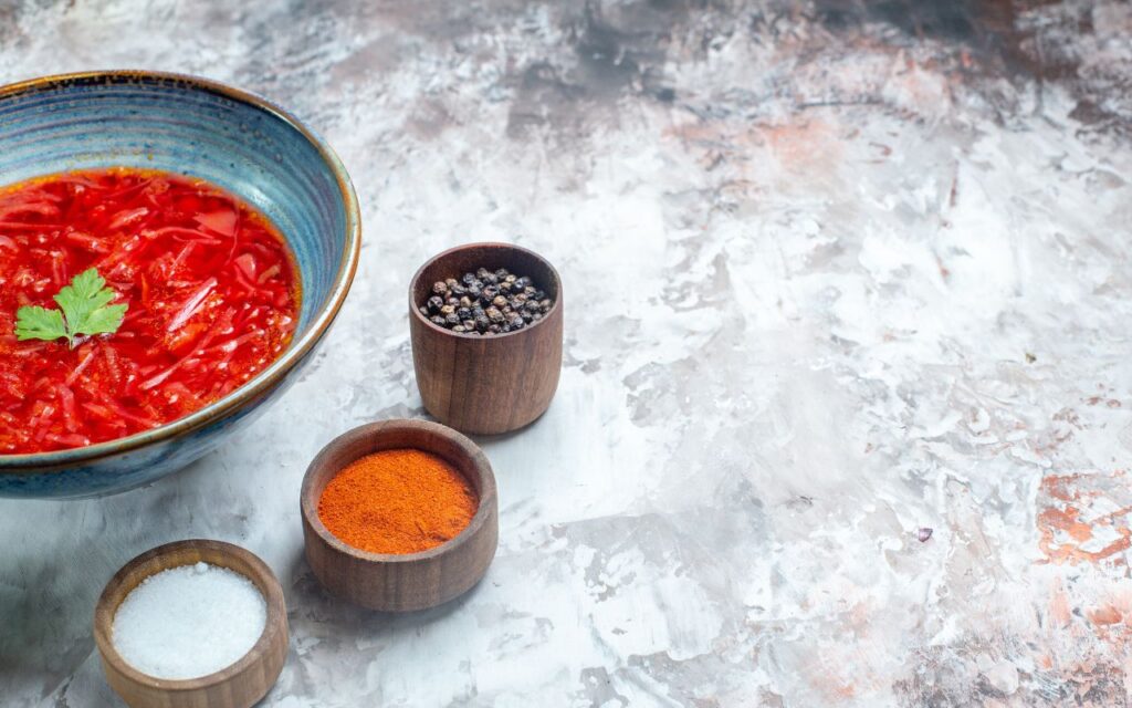 Gochujang gumbo with red broth, parsley, and side spices