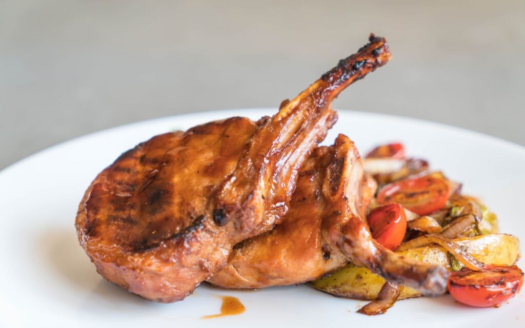 Grilled pork chops with roasted tomatoes