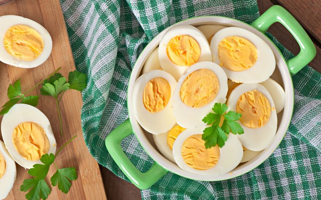 Bowl of halved hard-boiled eggs garnished with parsley