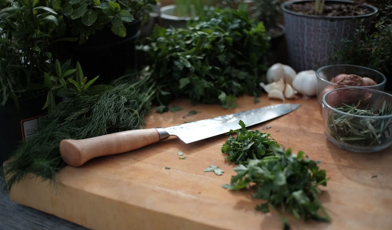 Herbs on wooden chopping board