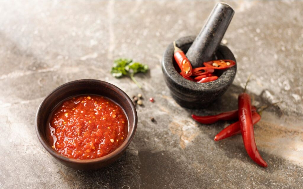 Bowl of red chili sauce with chilies