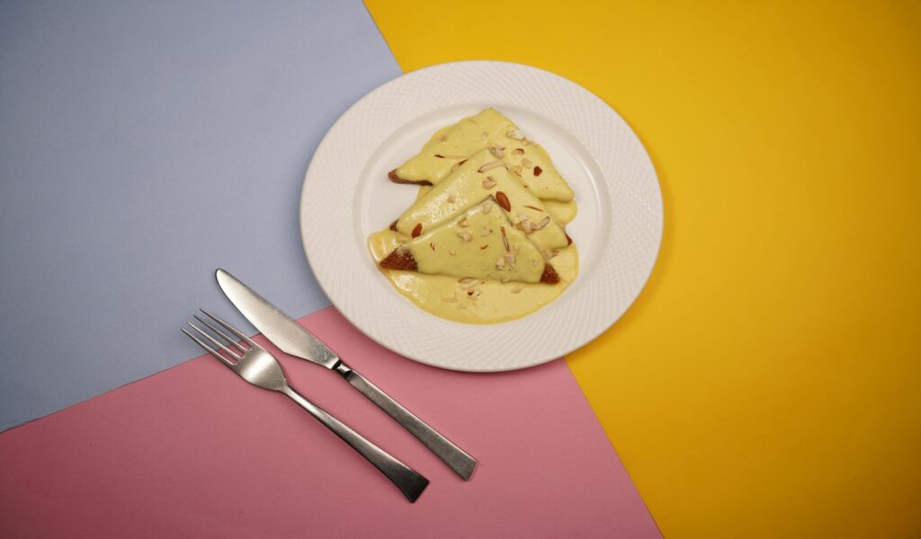 Top View of a Shahi Tukda Dish on a Plate against Colorful Background