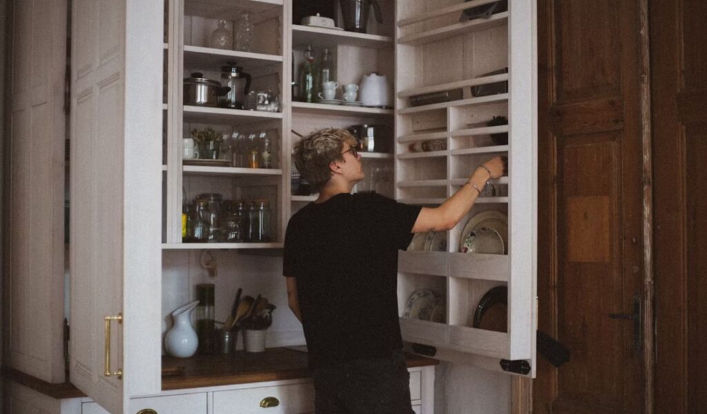 Man standing near cabinet