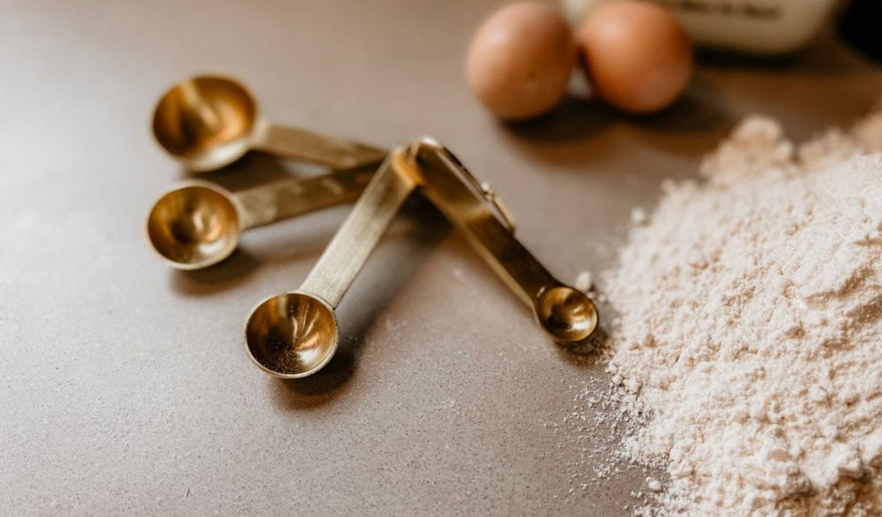 Measuring Spoons Beside Flour