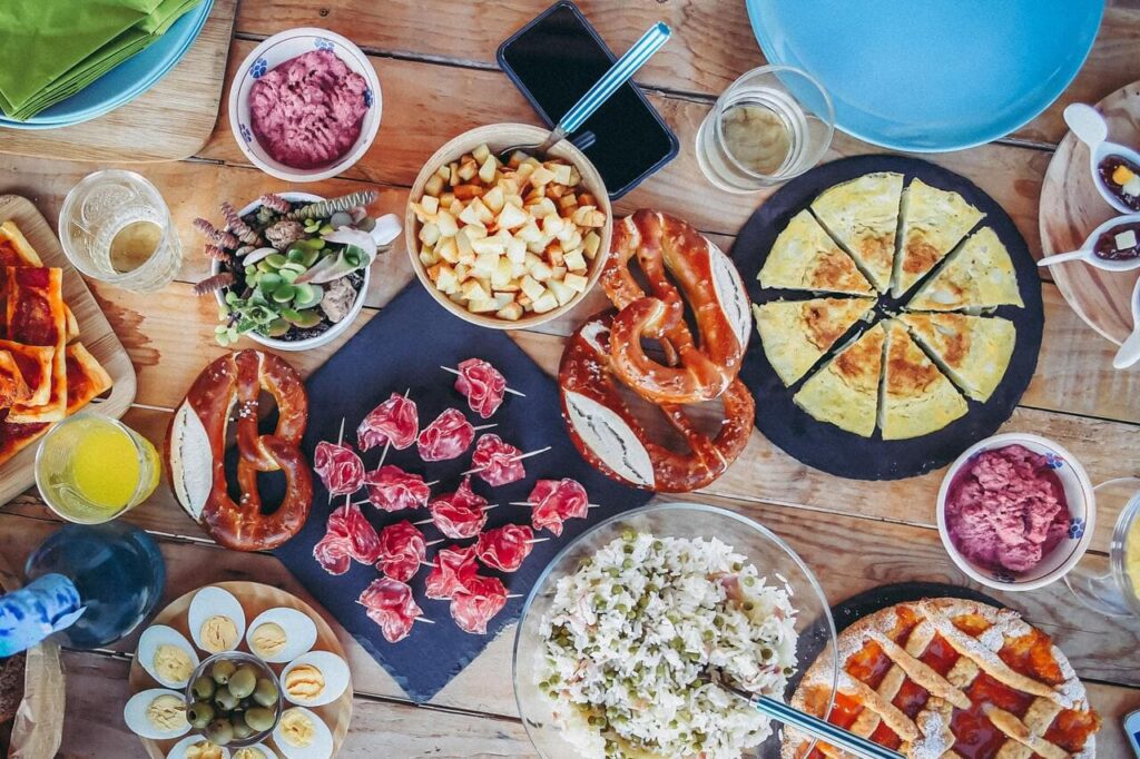 A collage or feast-style spread of all 13 dishes, presented in rustic or local restaurant settings.
