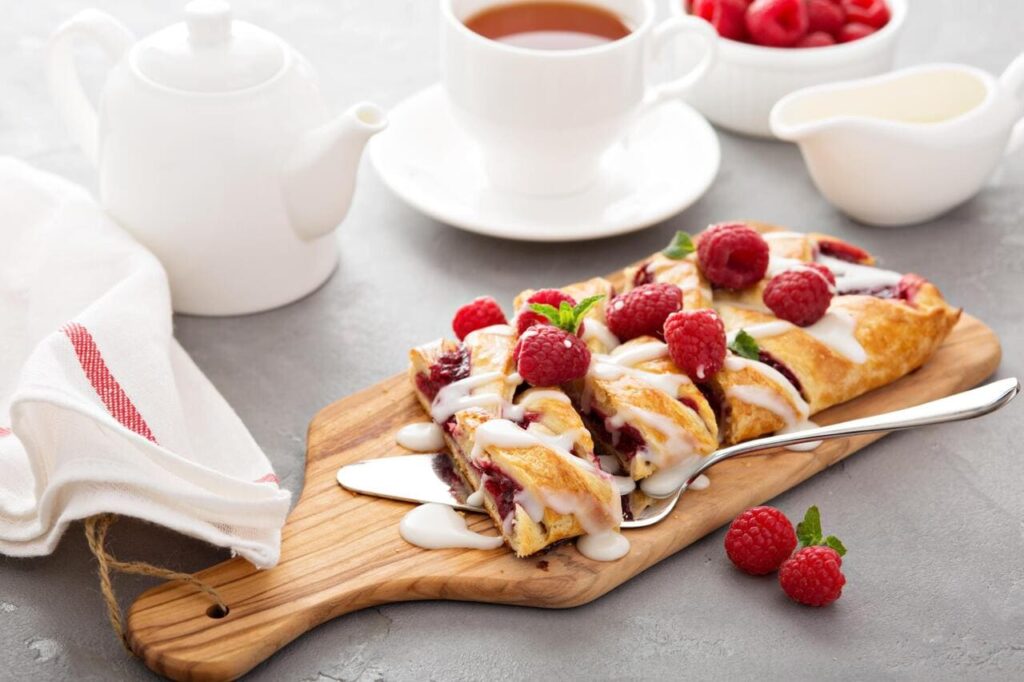 Braided raspberry danish with glaze and fresh berries