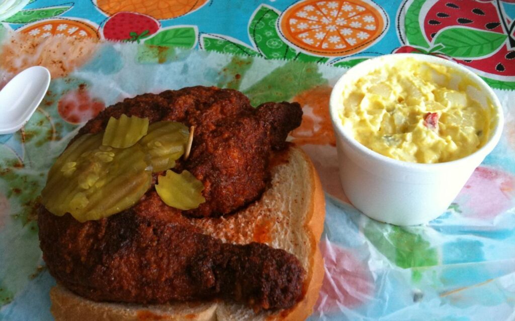 Nashville hot chicken sandwich with pickles and potato salad