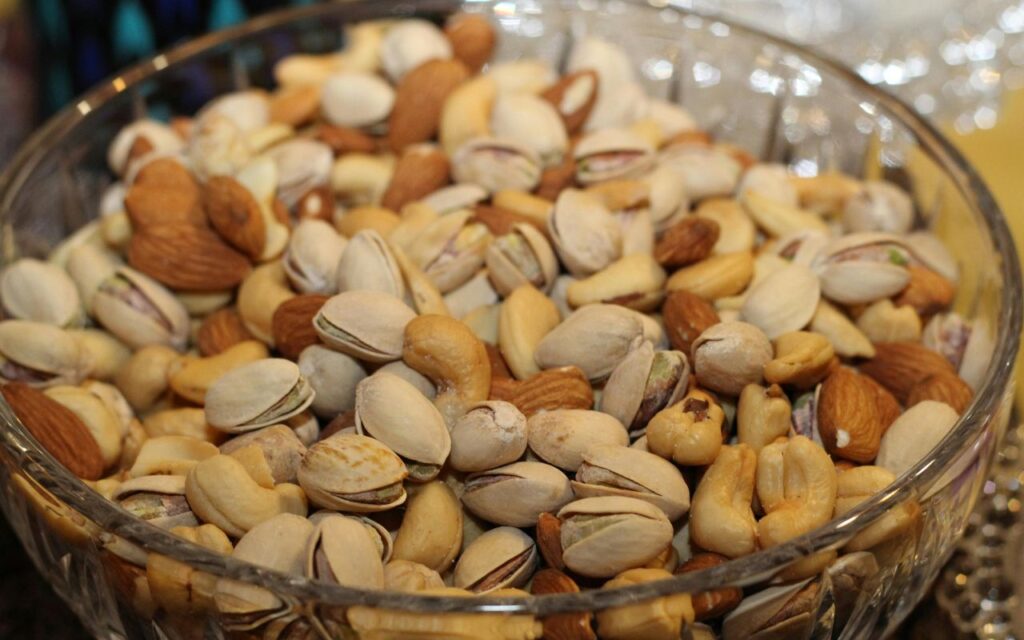A bowl of mixed nuts, including almonds, pistachios, cashews, and hazelnuts
