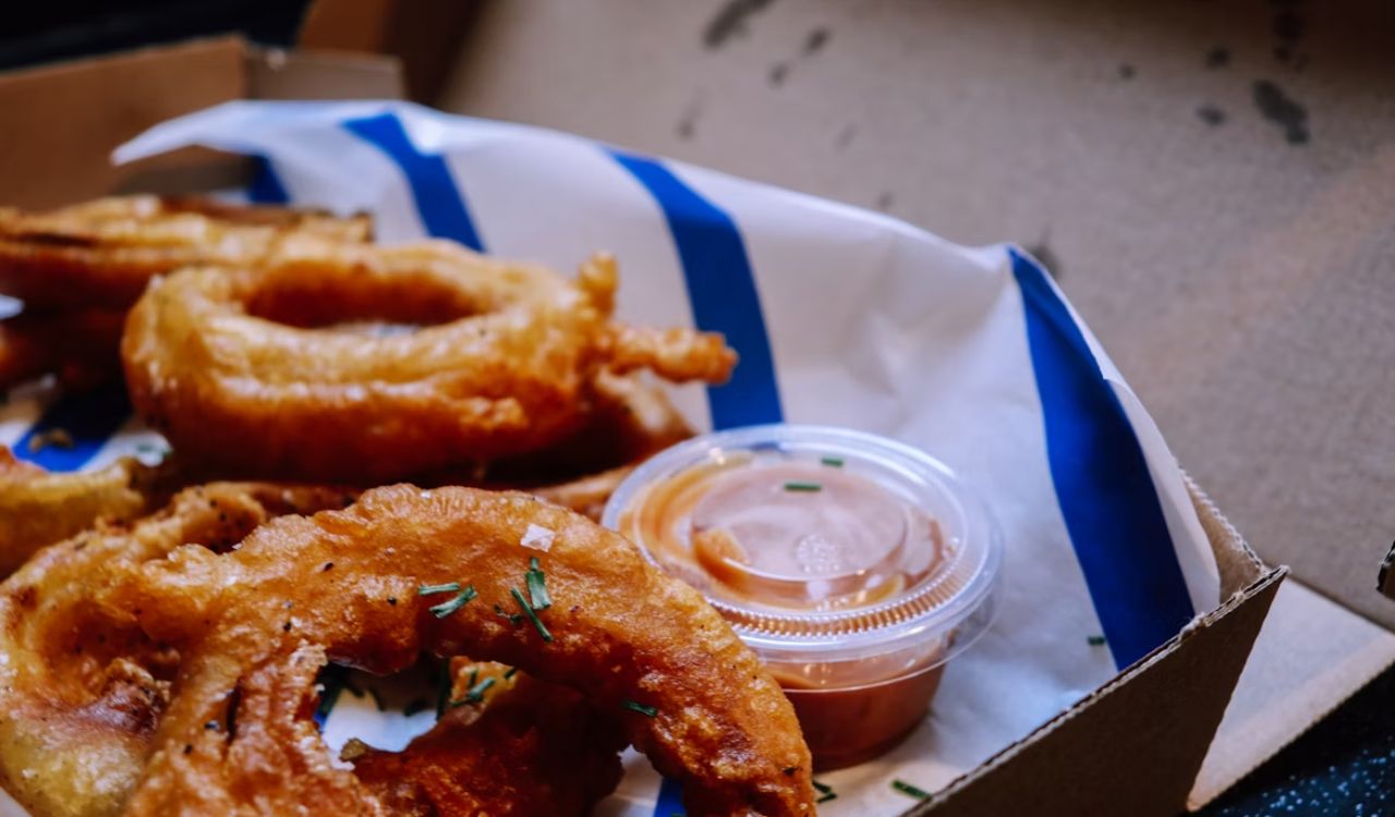 Onion rings on white and blue plastic container