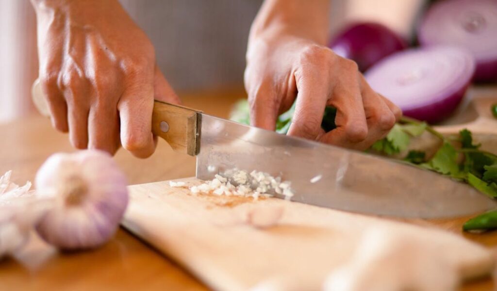 Person chopping garlic