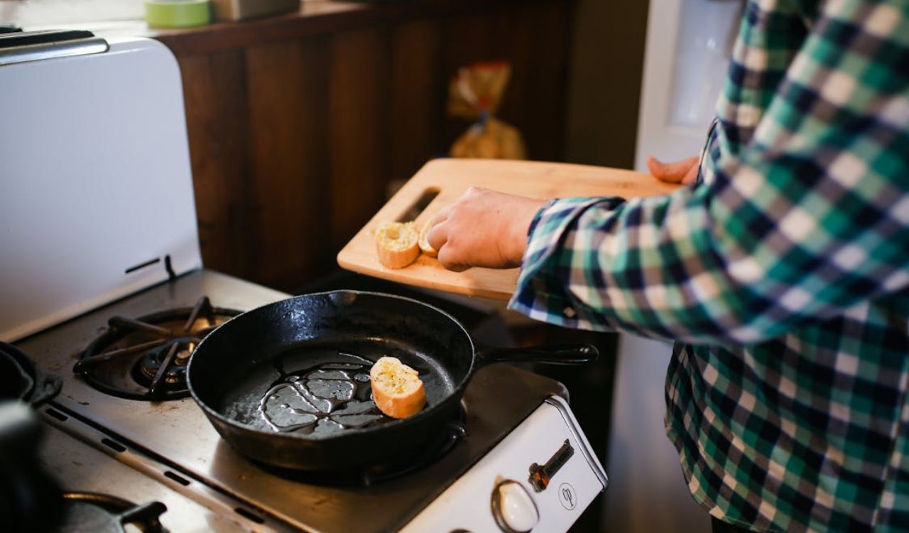 Person holding cast iron skillet