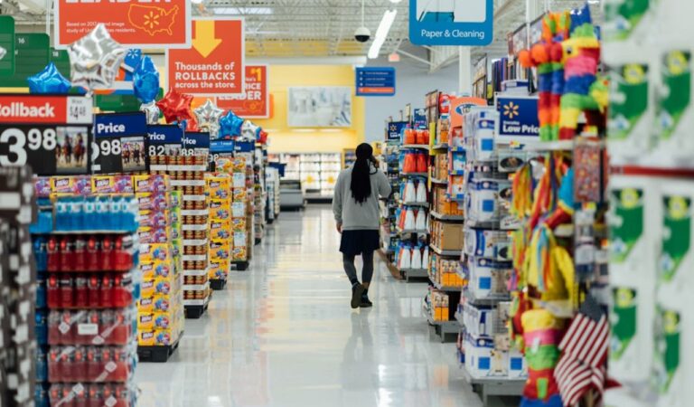Person standing between grocery shelves