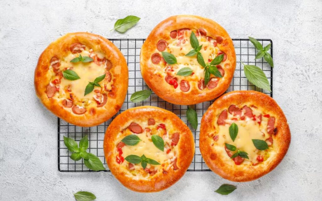 ChatGPT said: Mini pizza muffins topped with cheese, sausage, and basil