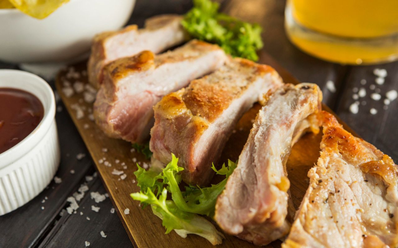 High angle of steak with salad and beer