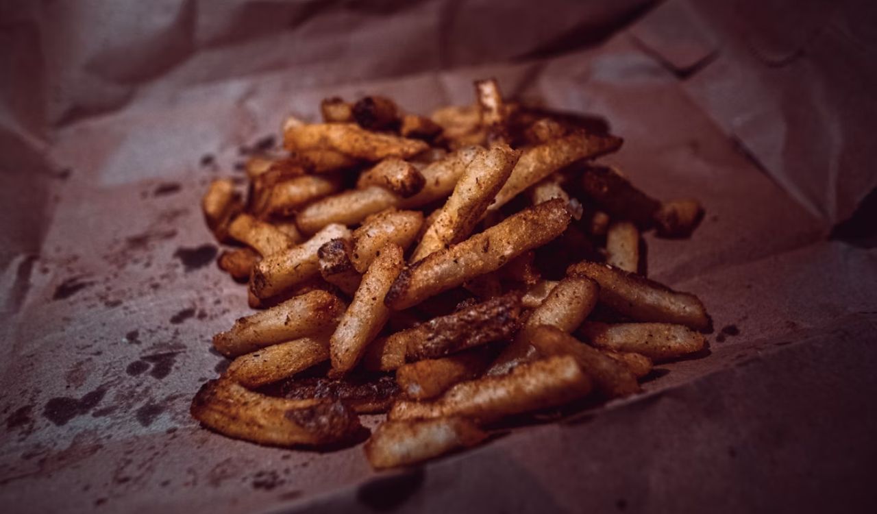 Potato fries on white paper