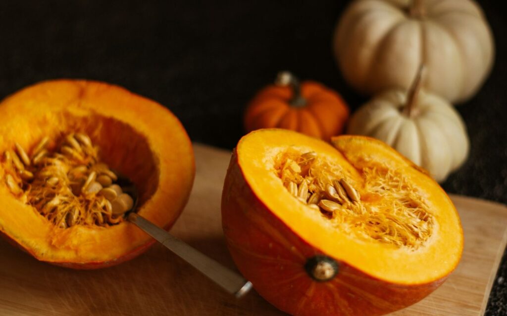Fresh pumpkin halves with seeds, ready for roasting into a healthy snack