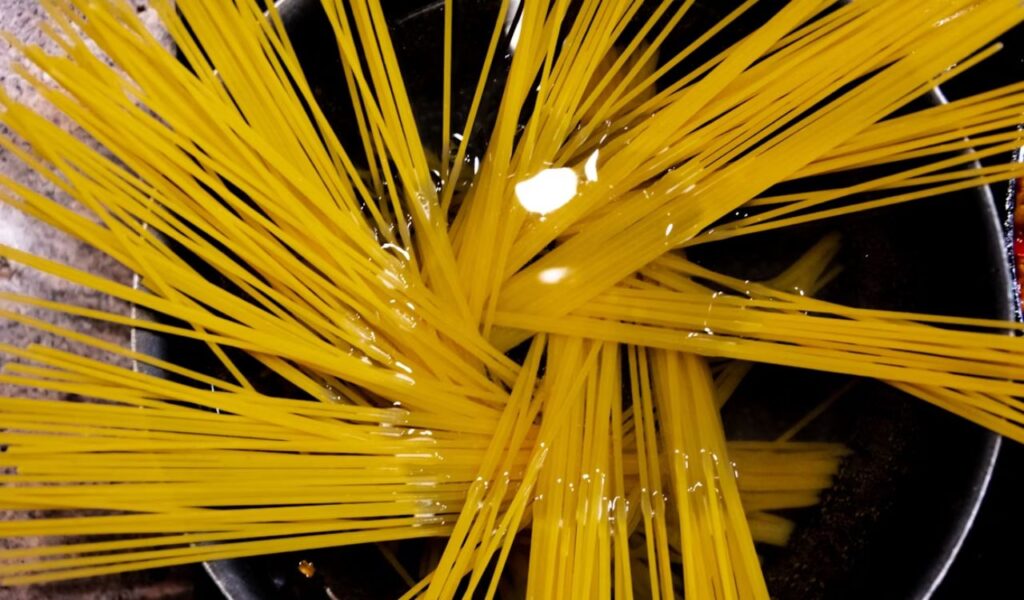 Raw pasta in pot