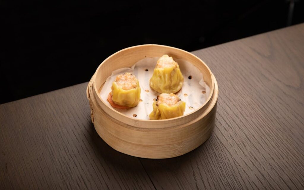 Siu mai dumplings in a bamboo steamer
