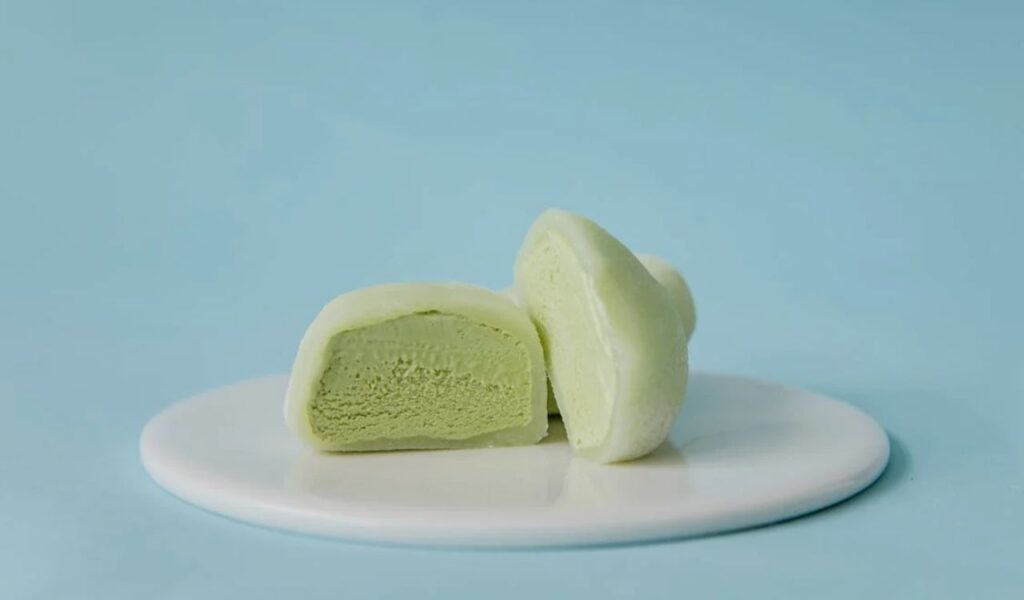 Sliced Green Mochi Ice Cream on White Ceramic Plate