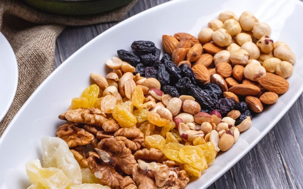 Bowl of assorted trail mix with nuts, dried fruits, and seeds
