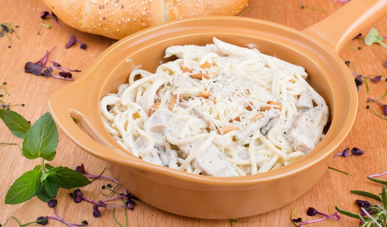 White pasta on ceramic pan- chicken alfredo