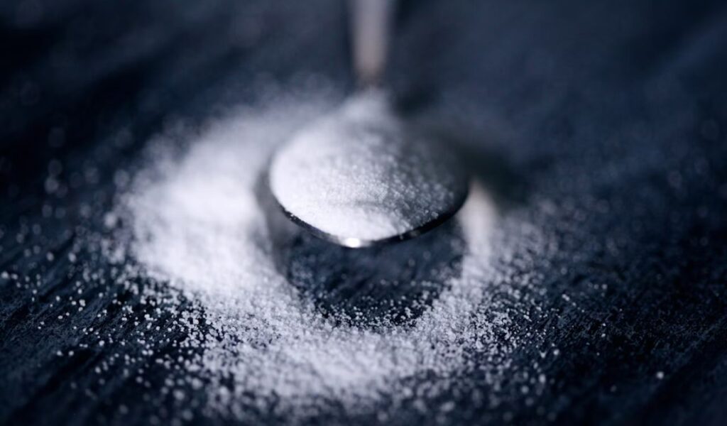 White sugar on a spoon.