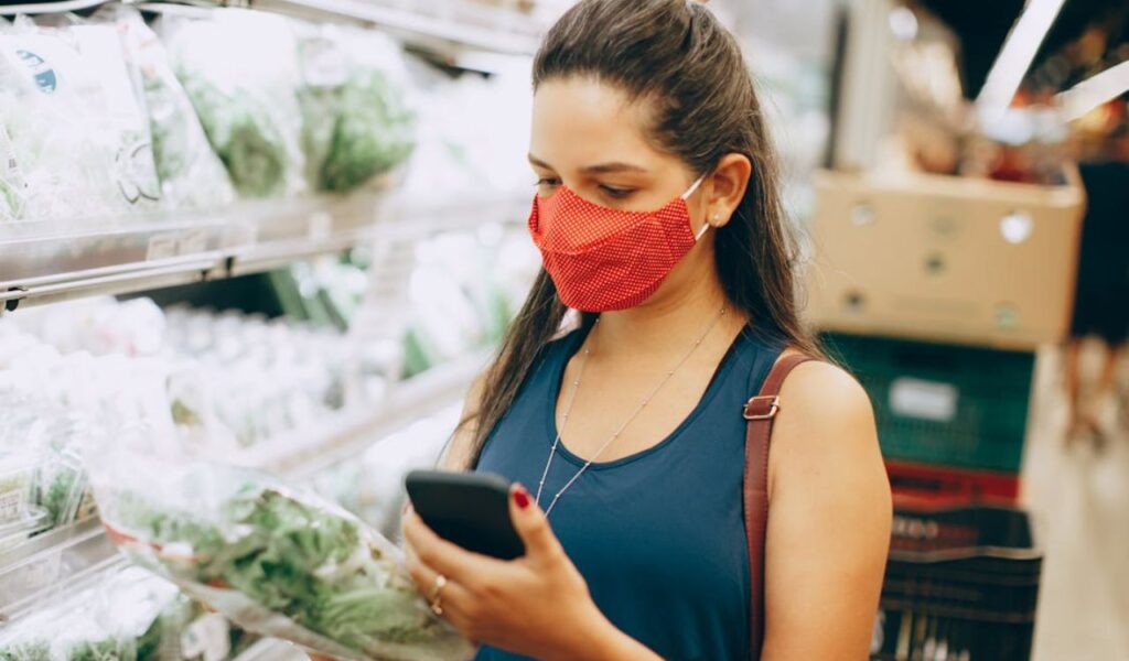 Woman in face mask shopping in supermarket