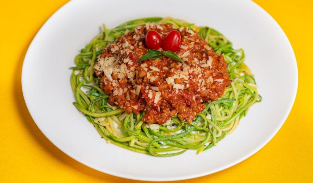 Zucchini Noodles with Bolognese Sauce on White Plate