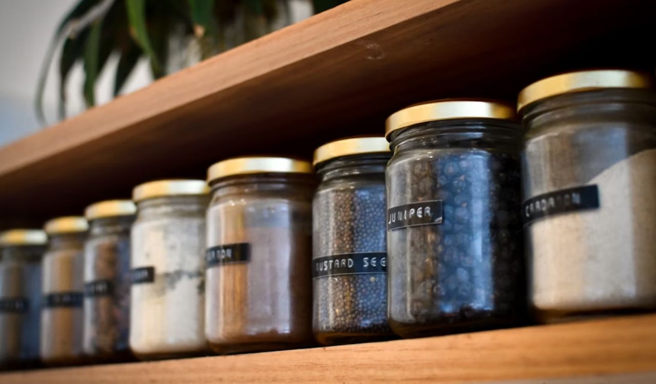a shelf filled with lots of different types of spices