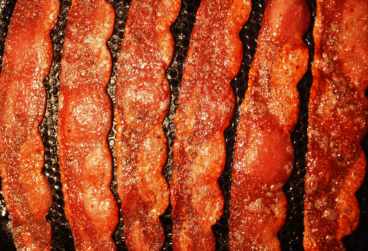 Crispy, darker-edged bacon strips fresh out of a 425°F oven.