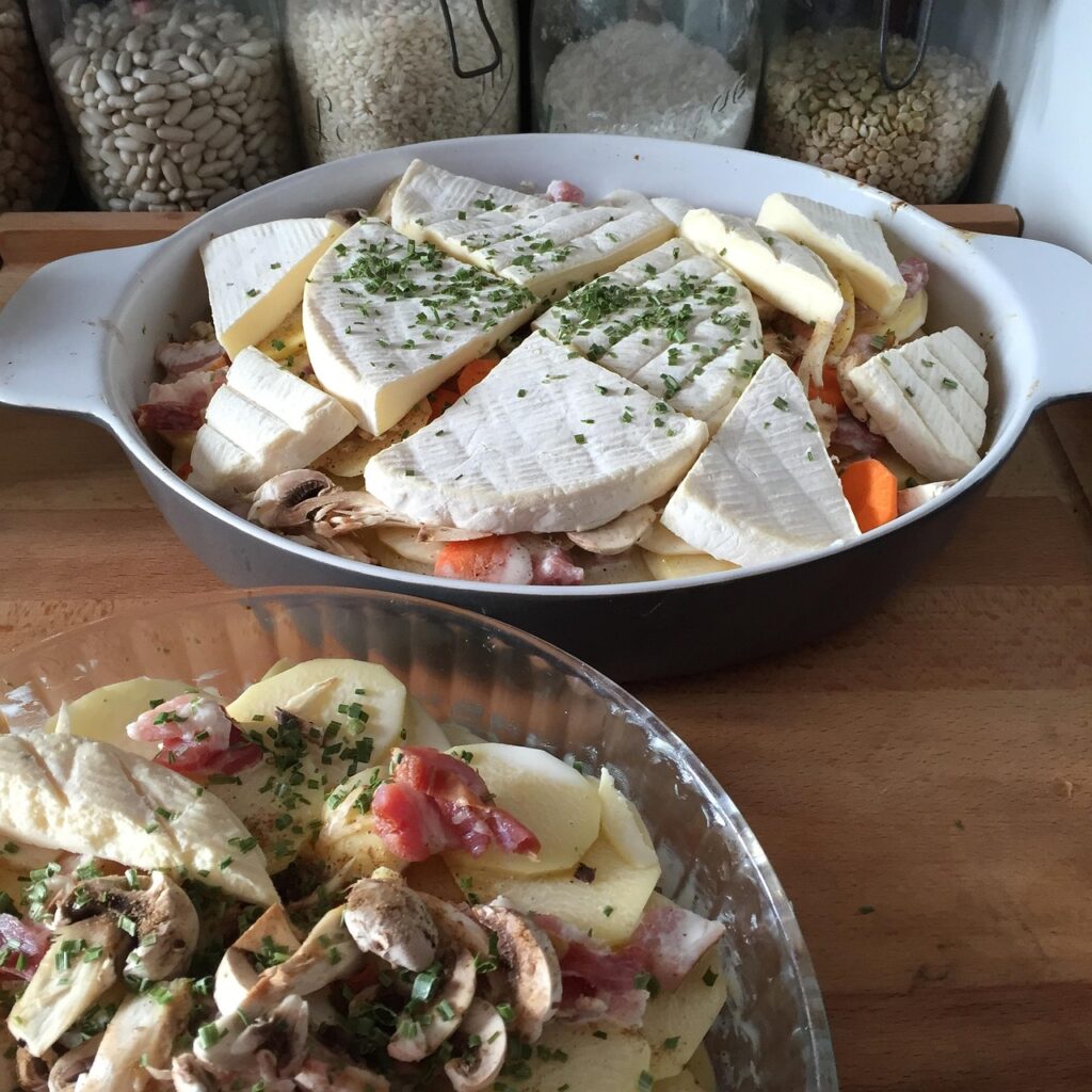 Reblochon cheese with potatoes and white wine glass for tartiflette.