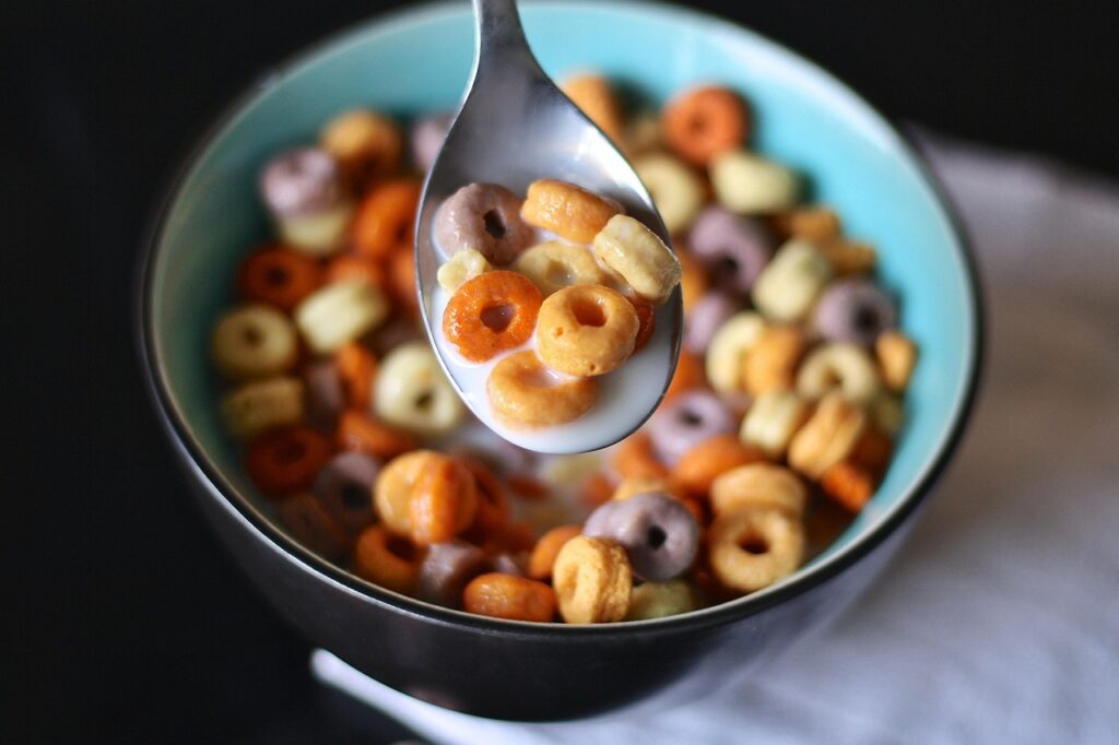 A bowl of Grape-Nuts cereal with milk and spoon, maybe with vintage packaging.