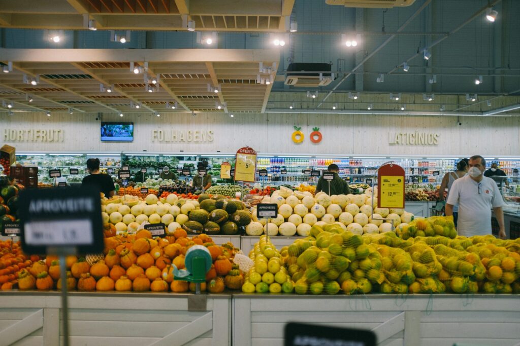 A visually busy supermarket aisle full of colorful displays and endcap promotions.