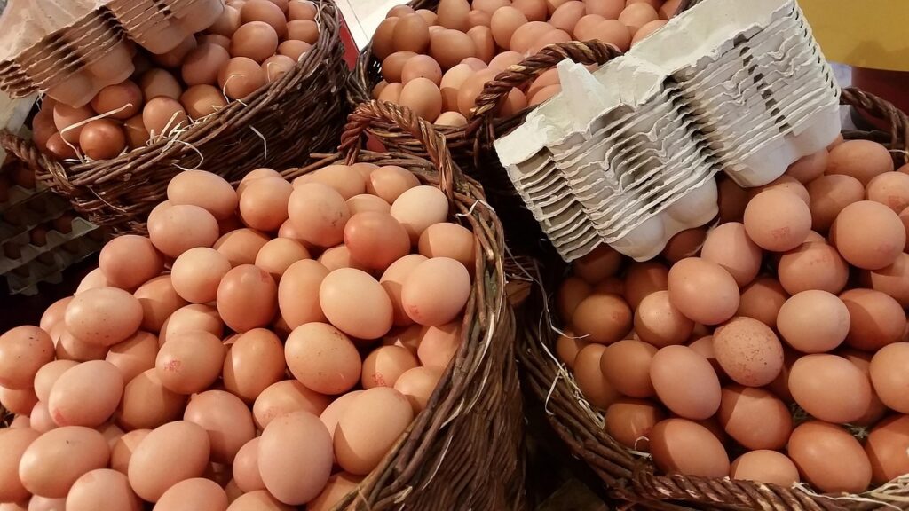 Farm-fresh eggs in rustic cartons with natural lighting.